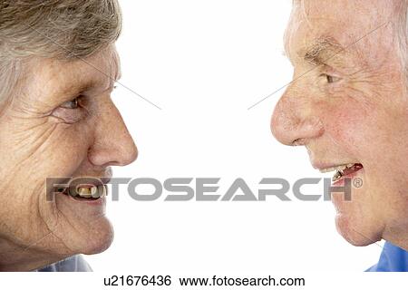 Stock Photograph - Portrait of senior couple smiling at each other. Fotosearch