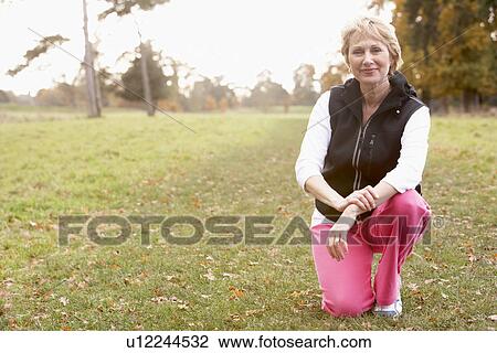 Portrait Of Senior Woman Crouching In The Park View Large Photo Image Stock Image - Portrait Of Senior Woman Crouching In The Park. Fotosearch
