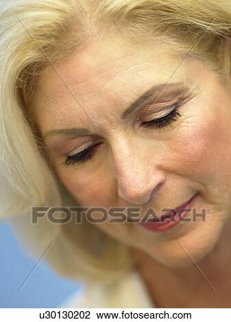 Stock Image - Portrait Of Senior Woman Looking Down. Fotosearch