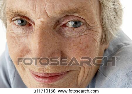 Portrait of senior woman smiling at the camera View Large Photo Image Stock Photo - Portrait of senior woman smiling at the camera. Fotosearch