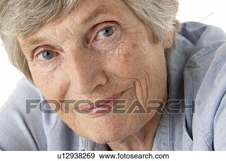 Stock Photo - Portrait of senior woman smiling at the camera. Fotosearch