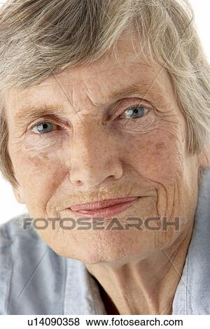 Portrait of senior woman smiling at the camera View Large Photo Image Stock Photo - Portrait of senior woman smiling at the camera. Fotosearch
