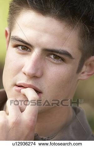 Portrait Of Teenage Boy Biting Nails View Large Photo Image Picture - Portrait Of Teenage Boy Biting Nails. Fotosearch