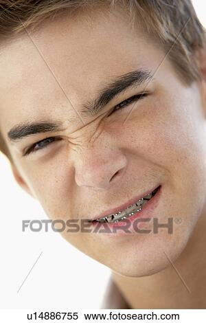 Stock Photography - Portrait Of Teenage Boy Looking Grumpy. Fotosearch
