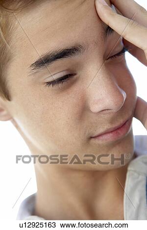 Portrait Of Teenage Boy Rubbing Temples View Large Photo Image Stock Image - Portrait Of Teenage Boy Rubbing Temples. Fotosearch