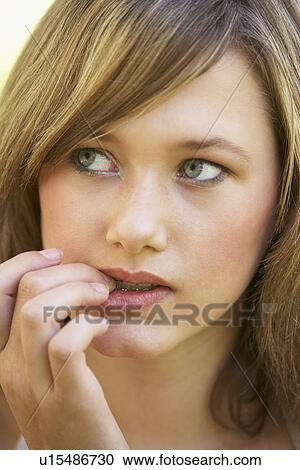 Portrait Of Teenage Girl Biting Nails View Large Photo Image Stock Image - Portrait Of Teenage Girl Biting Nails. Fotosearch