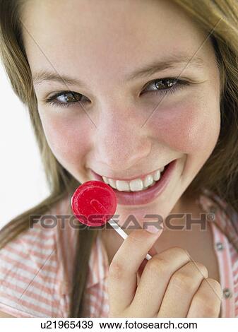 Stock Photo - Portrait Of Teenage Girl Eating Lollipop. Fotosearch
