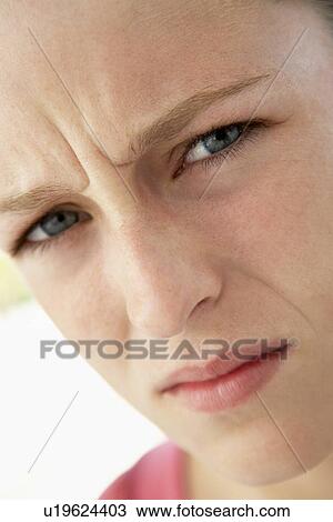 Stock Image - Portrait Of Teenage Girl Frowning. Fotosearch