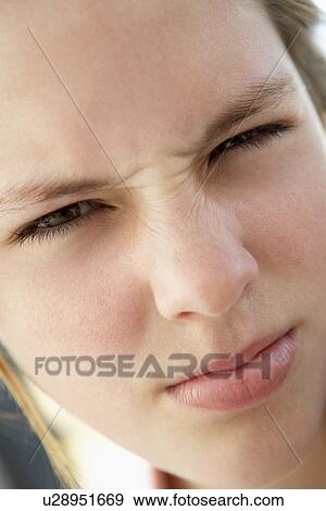 Stock Photo - Portrait Of Teenage Girl Frowning. Fotosearch