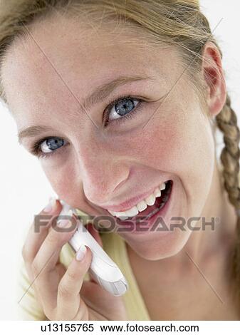 Stock Photography - Portrait Of Teenage Girl Smiling And Talking On Cellphone. Fotosearch