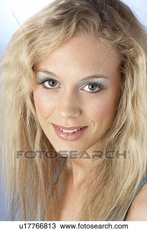 Stock Image - Portrait Of Young Woman Looking At Camera. Fotosearch