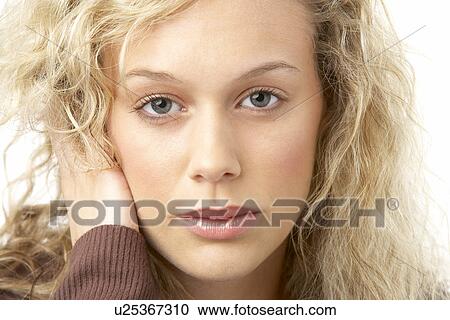 Stock Image - Portrait Of Young Woman Looking At Camera. Fotosearch