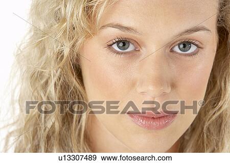 Stock Photo - Portrait Of Young Woman Looking At Camera. Fotosearch