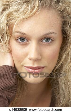 Stock Photo - Portrait Of Young Woman Looking At Camera. Fotosearch