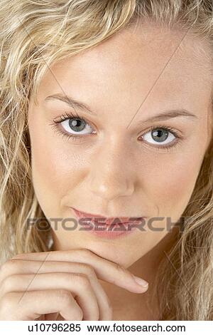Stock Photography - Portrait Of Young Woman Looking At Camera. Fotosearch