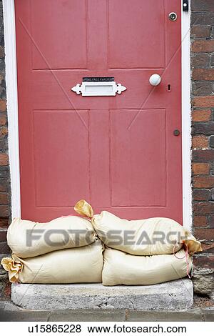 Sandbags Stacked In A Doorway In Preparation For Flooding View Large Photo Image Stock Photo - Sandbags Stacked In A Doorway In Preparation For Flooding. Fotosearch