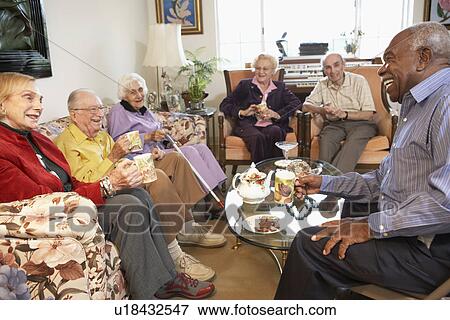 Stock Photo - Senior adults having morning tea together. Fotosearch
