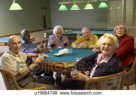 Stock Photo - Senior adults playing bridge. Fotosearch