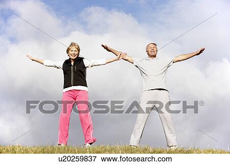 Stock Photo - Senior Couple Exercising In The Park. Fotosearch