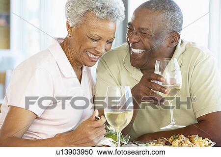 Stock Image - Senior Couple Having Lunch Together At A Restaurant. Fotosearch