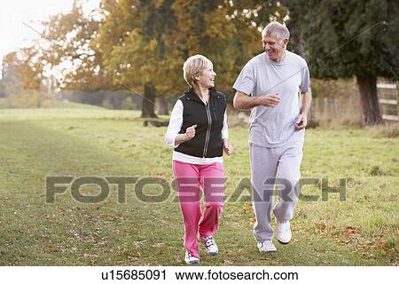 Senior Couple Power Walking In The Park View Large Photo Image Stock Image - Senior Couple Power Walking In The Park. Fotosearch
