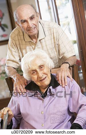 Stock Photo - Senior couple relaxing in armchairs. Fotosearch