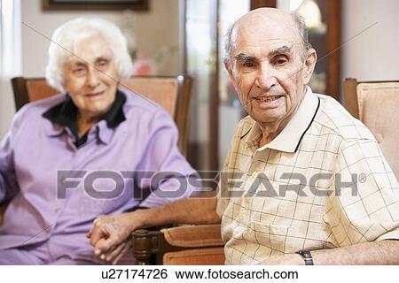 Senior couple relaxing in armchairs View Large Photo Image Stock Photograph - Senior couple relaxing in armchairs. Fotosearch