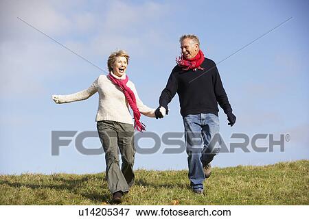 Stock Photo - Senior Couple Running In The Park. Fotosearch