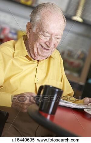 Stock Photography - Senior man drinking hot beverage. Fotosearch