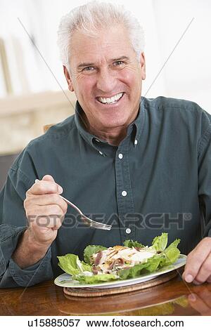 Stock Photo - Senior Man Eating A Healthy Meal. Fotosearch