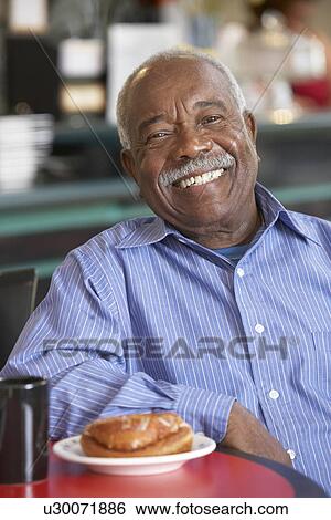 Senior man having morning tea View Large Photo Image Stock Photograph - Senior man having morning tea. Fotosearch