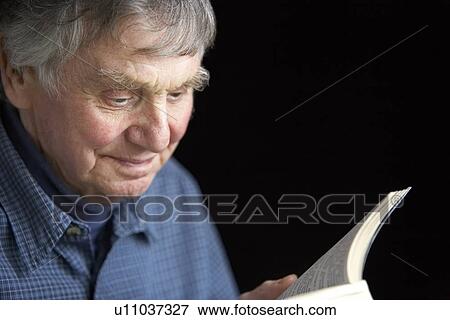 Stock Photo - Senior man reading a book. Fotosearch