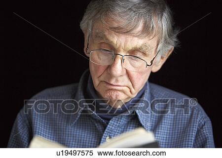 Senior man reading a book View Large Photo Image Stock Photography - Senior man reading a book. Fotosearch