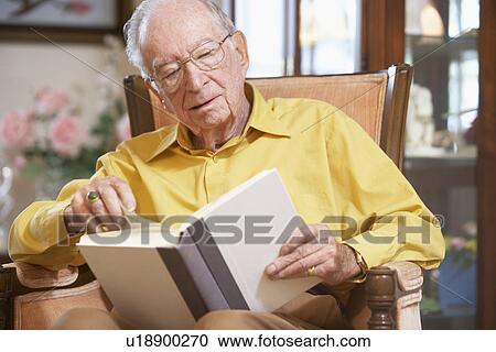 Stock Image - Senior man reading book. Fotosearch
