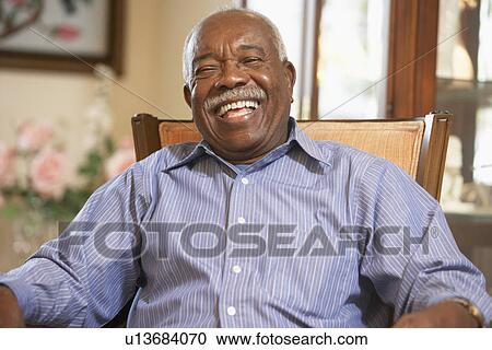 Stock Image - Senior man relaxing in armchair. Fotosearch