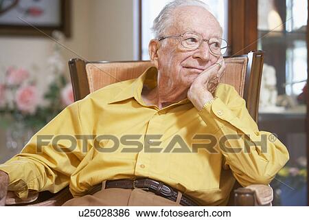 Stock Photograph - Senior man relaxing in armchair. Fotosearch