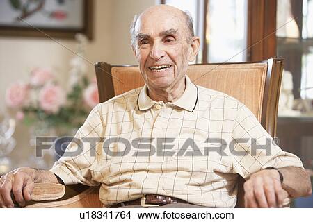 Senior man resting in armchair View Large Photo Image Picture - Senior man resting in armchair. Fotosearch