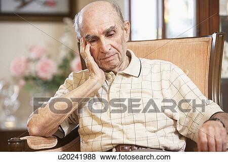 Stock Photo - Senior man resting in armchair. Fotosearch