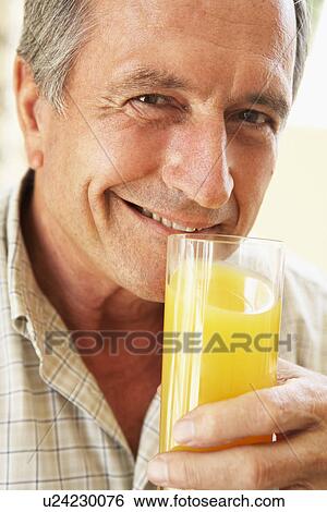 Senior Man Smiling At Camera And Drinking Orange Juice View Large Photo Image Stock Photograph - Senior Man Smiling At Camera And Drinking Orange Juice. Fotosearch