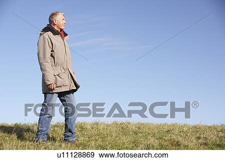 Stock Photo - Senior Man Standing In Park. Fotosearch