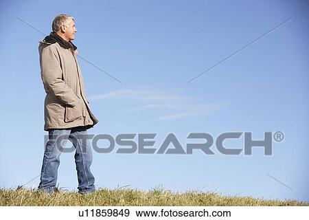 Stock Photo - Senior Man Standing In Park. Fotosearch