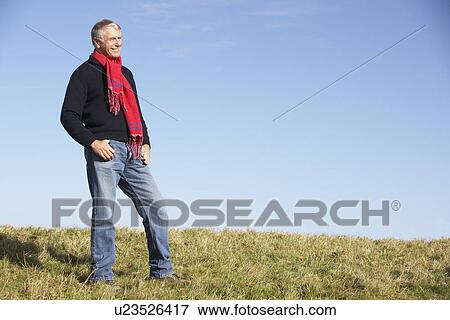 Stock Photo - Senior Man Standing In Park. Fotosearch