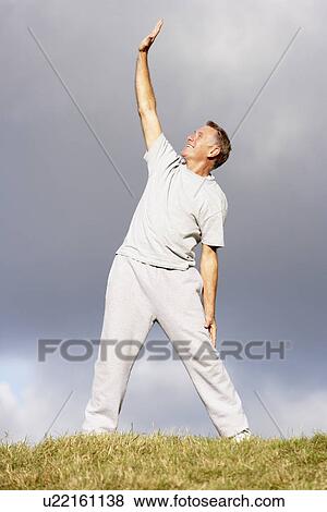 Senior Man Stretching In The Park View Large Photo Image Stock Photo - Senior Man Stretching In The Park. Fotosearch