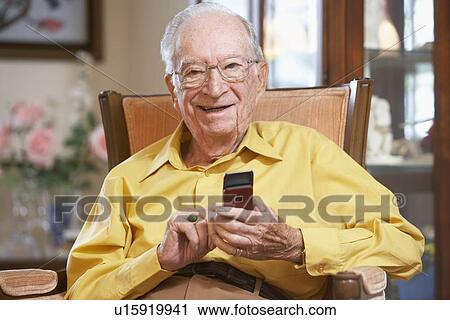Stock Image - Senior man text messaging. Fotosearch