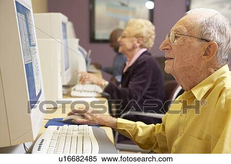 Senior man using computer View Large Photo Image Stock Photography - Senior man using computer. Fotosearch