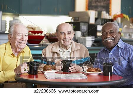 Stock Photograph - Senior men drinking tea together. Fotosearch