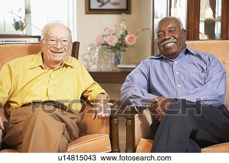 Stock Image - Senior men relaxing in armchairs. Fotosearch
