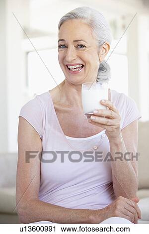 Stock Image - Senior Woman Drinking A Glass Of Milk. Fotosearch