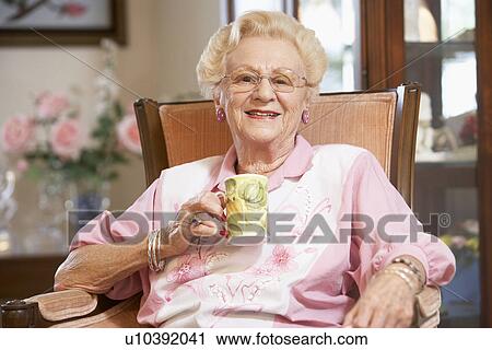 Senior woman drinking hot beverage View Large Photo Image Stock Image - Senior woman drinking hot beverage. Fotosearch