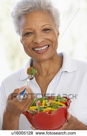 Senior Woman Eating A Fresh Green Salad View Large Photo Image Stock Photo - Senior Woman Eating A Fresh Green Salad. Fotosearch